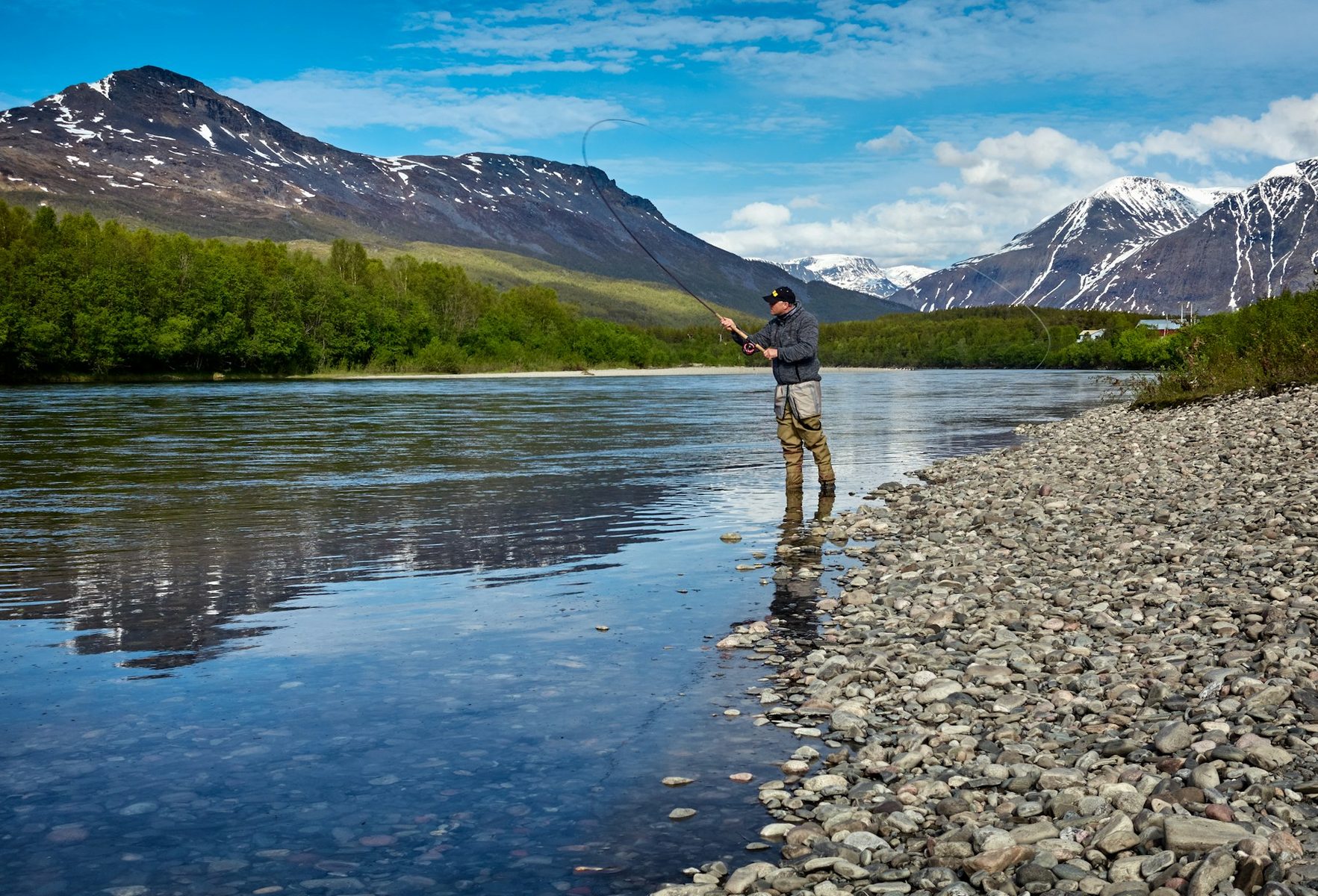 An angler fishing in a mountain river